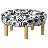 Elegante pouf rotondo a motivi bianchi e neri con gambe in legno.