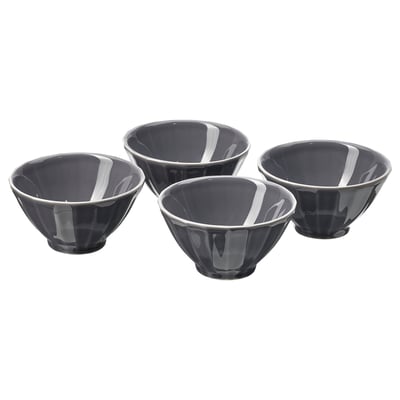 Quattro ciotole in ceramica nera con motivi floreali bianchi, disposte in un quadrato.