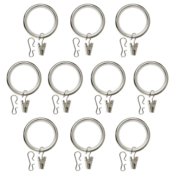 Dodici anelli per tende nichelati, metà con clip, metà con ganci, disposti ordinatamente.