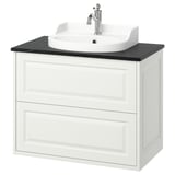 TÄNNFORSEN lavabo a parete bianco con piano di lavoro nero e lavello rotondo.