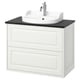 TÄNNFORSEN lavabo a parete bianco con piano di lavoro nero e lavello rotondo.