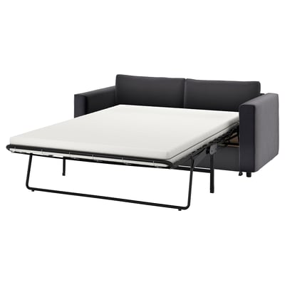 Divano letto moderno nero con gambe in metallo.