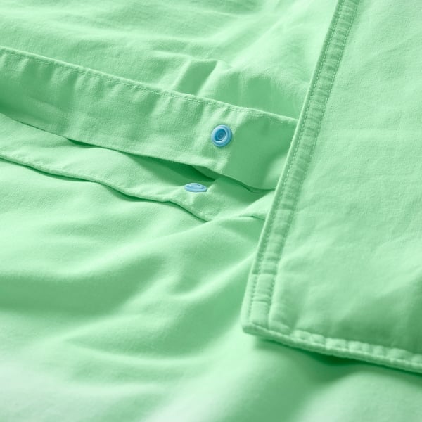 Light green duvet cover set with button closure, made of soft, breathable cotton.