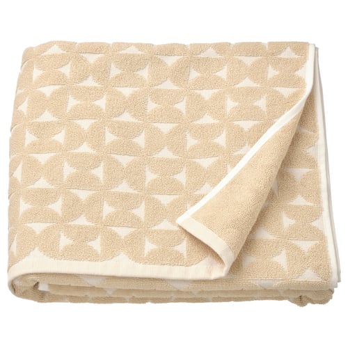 Beige towel with white star pattern, folded neatly.
