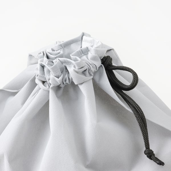 Close-up of durable, white recycling bag with black drawstring, designed for dry waste sorting.