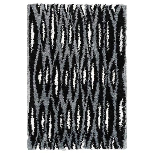 Black and white striped rectangular rug with a shaggy texture. Part of the nytillverkad collection, it a modern design with diagonal patterns.