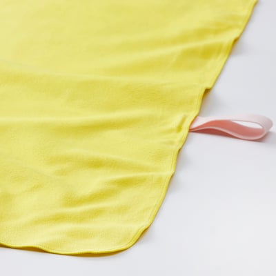 Bright yellow fitness towel with pink hanging loop, laid flat on white surface.