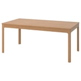 A light brown ikea EKEDALEN wooden dining table with a rectangular top and four corner legs.