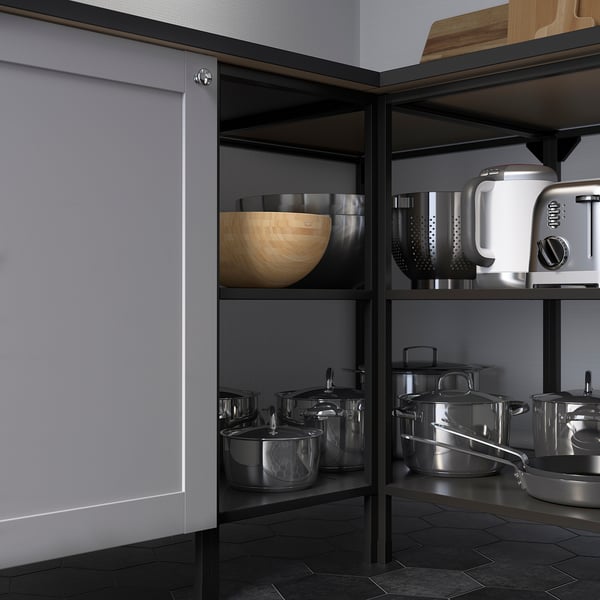 Modern kitchen shelves with cookware. Shiny pots, pans, and mixer. Stainless steel and wooden bowl.