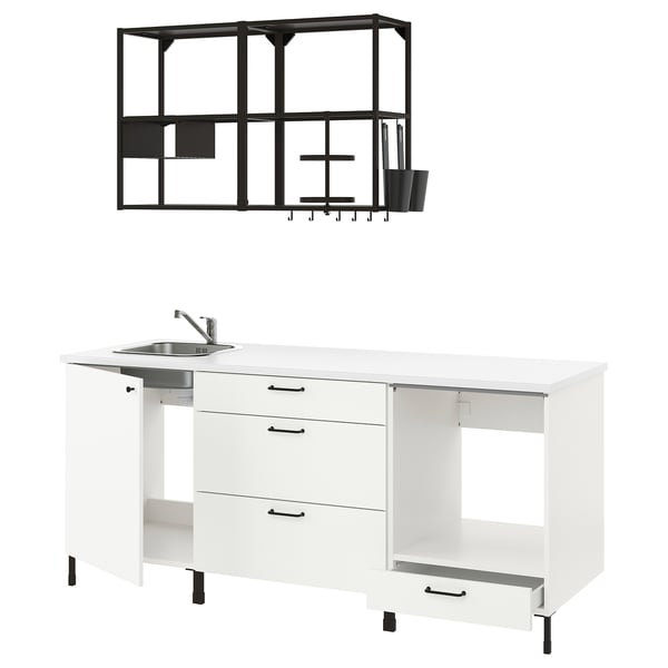 Displays a white ENHET kitchen setup with black handles and a black metal wall shelf.