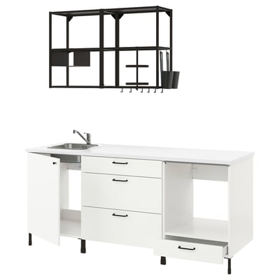 Displays a white ENHET kitchen setup with black handles and a black metal wall shelf.