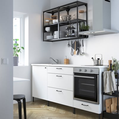 Modern white kitchen with ENHET, spacious drawers, integrated appliances, open shelving, stainless steel sink, streamlined for small spaces.