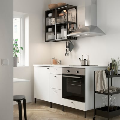 Modern compact white kitchen with ENHET series, integrated oven/sink, open shelves, and stainless steel accents.