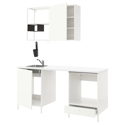 Modern white kitchen setup with cabinets, sink, and tap.
