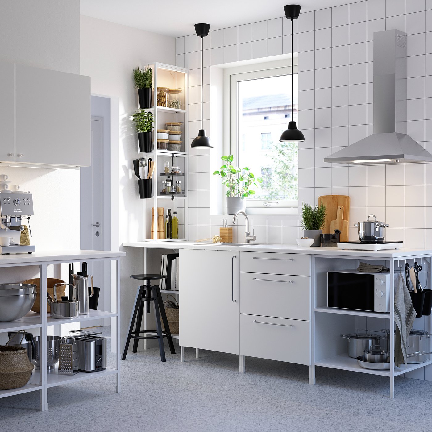 Modern white kitchen with stainless steel appliances, hanging lighting, and open shelving.