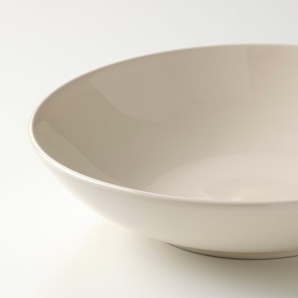 Flat, off-white plate with smooth, glossy surface and thin rim. Perfect for serving meals in a stylish manner.