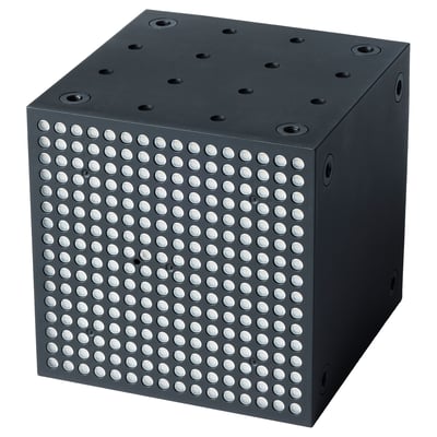 Black cube speaker with metallic dots, square shape, sound-sensitive lighting.