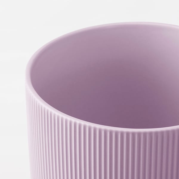 Close-up of a smooth, pastel purple pottery jar with vertical grooves, showcasing its textured surface and fine craftsmanship.