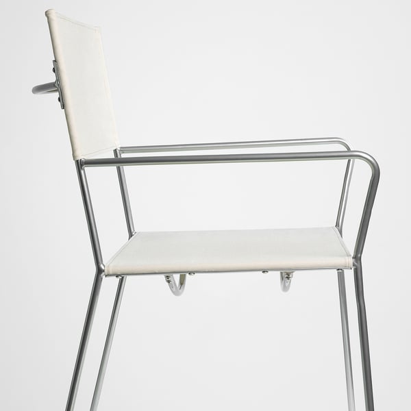 Modern chair with sturdy metal frame, armrests, and fabric seat/back, perfect for comfort and style.