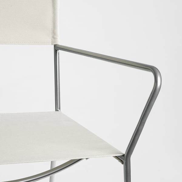 Modern chair with silver metal frame and white fabric seat/backrest, showcasing clean design and sturdy construction.