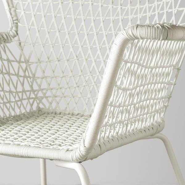 Close-up of a modern white wicker chair, showcasing its intricate weave and sleek design.