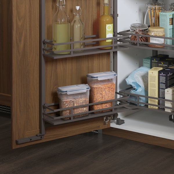 Kitchen cabinet with pull-out shelves and organised IKEA jars and bottles.