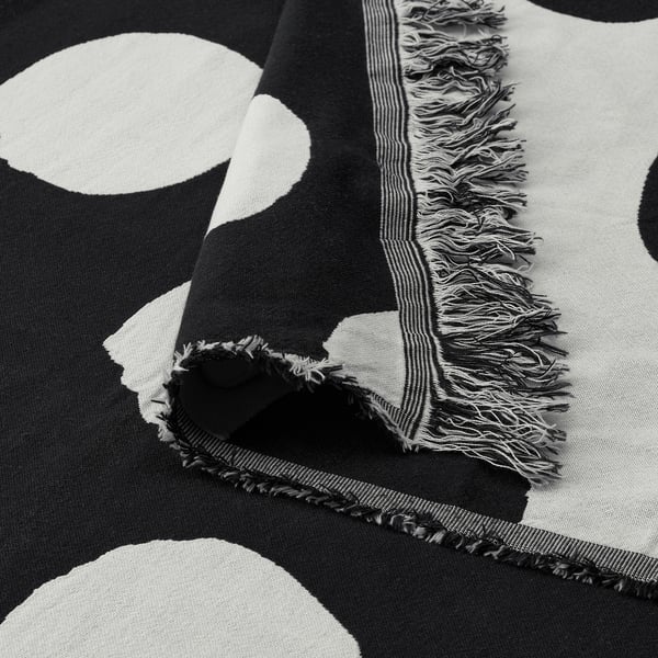 Black and white patterned throw blanket with fringe, high-quality cotton texture, stylish dots.
