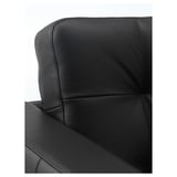 Black leather chair close-up; smooth, strong grain with detailed stitching.