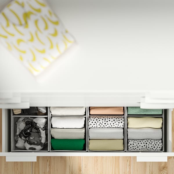 Organised drawer with folded clothes, featuring automatic drawer closure mechanism.