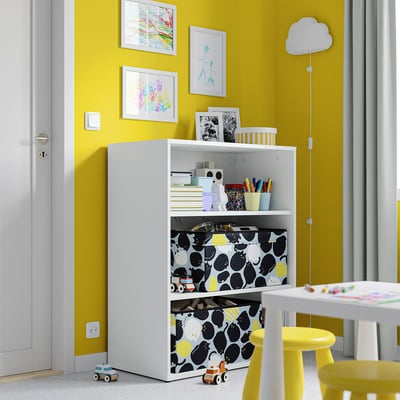 Yellow kids room with bookshelf, toys, colourful art, and cloud lamp.