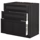 Modern black kitchen cabinet with three drawers, sleek design.