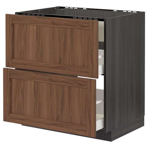 Modern kitchen unit with walnut drawers and black frame.