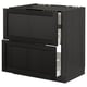 Black stained wooden kitchen cabinet with bevelled edges and open drawer.