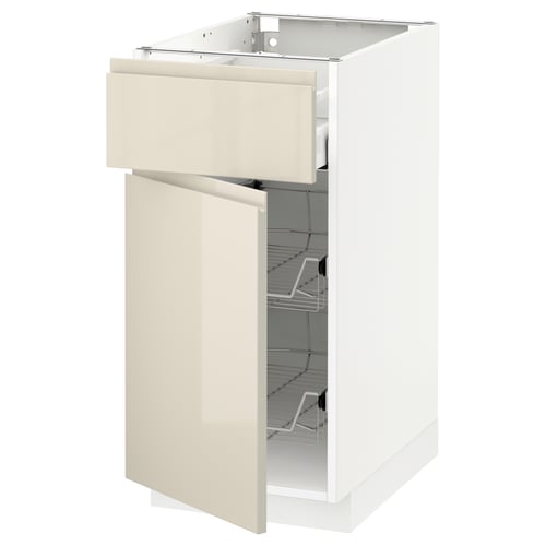 A white IKEA METOD kitchen base cabinet with a beige glossy drawer and door, featuring metal wire shelves inside.
