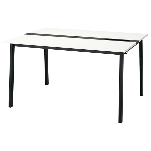 The MITTZON table a white top and black metal legs, providing a modern, minimalist design.