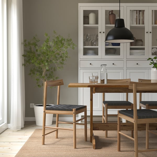 NACKANÄS dining table, acacia wood, seats 6-8, minimalist design, large size, with chairs and decor.