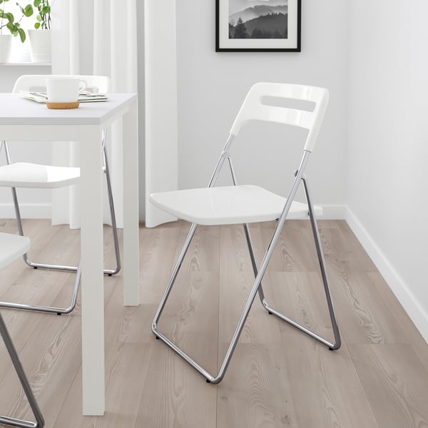 White NISSE foldable chair, compact, lightweight, modern design.
