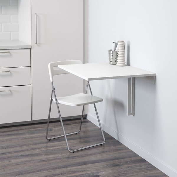 Wall-mounted table folds away to save space. Ideal for small areas, with a white, easy-to-clean top.