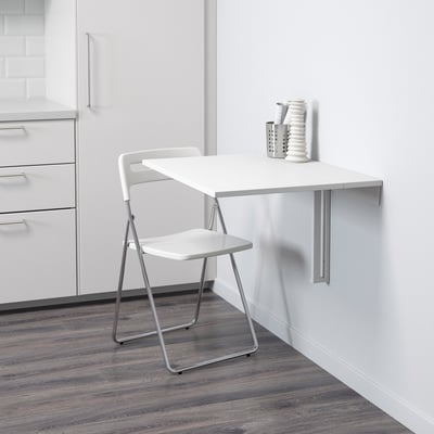 Wall-mounted table folds away to save space. Ideal for small areas, with a white, easy-to-clean top.