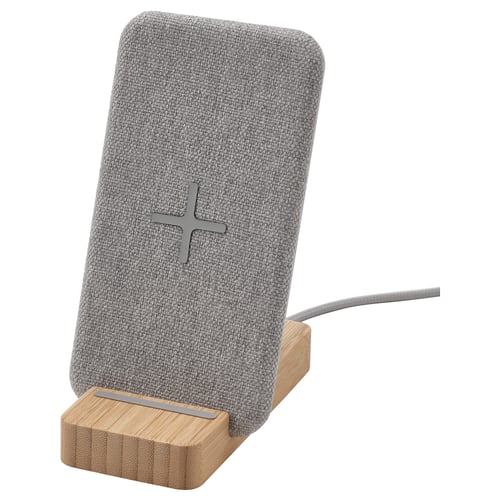 Nordmarke grey wireless phone charger on bamboo stand, stylish home office decor.