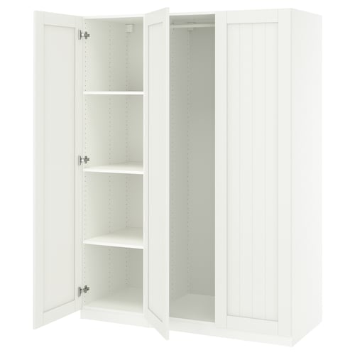 A white ikea PAX wardrobe with open doors revealing shelves. Simple, modern design.
