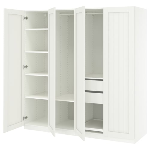 A white IKEA PAX wardrobe with open doors, revealing empty shelves and drawer spaces.