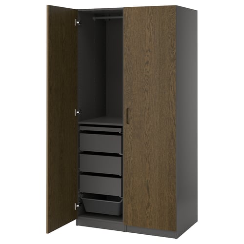 An open PAX wardrobe in dark wood tone, showcasing drawers and a clothes rail.