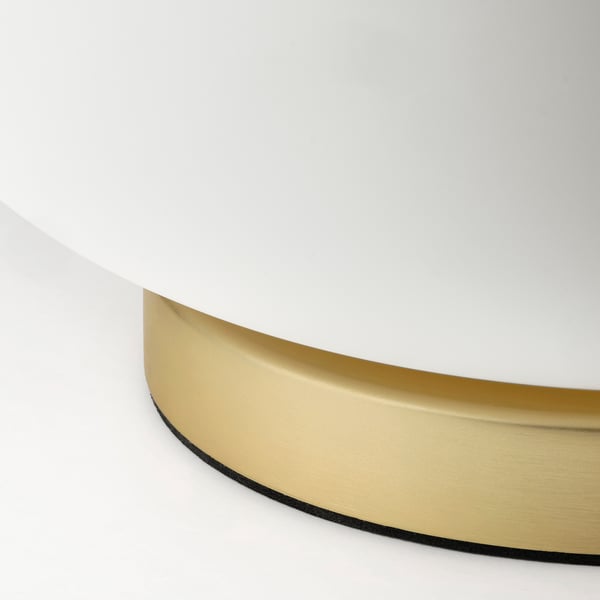 Elegant modern lamp with gold metal base and frosted glass shade.