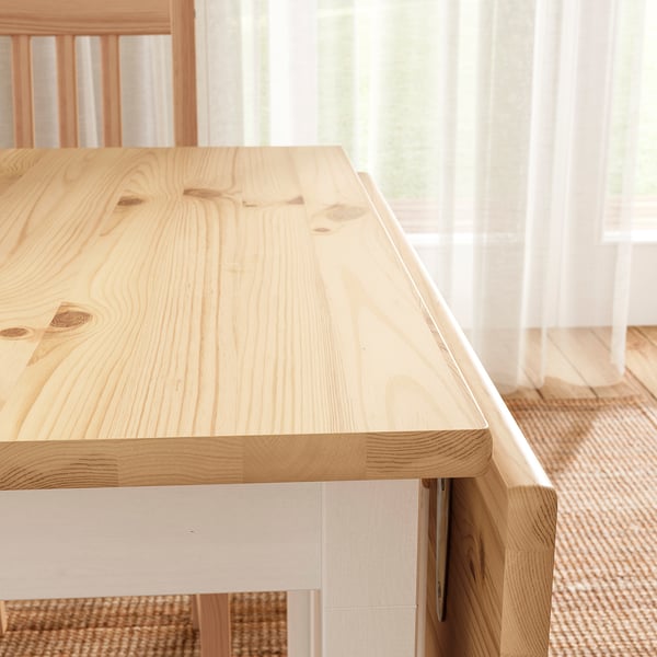 Modern lacquered pine table with visible wood grain; clean, minimalist design.