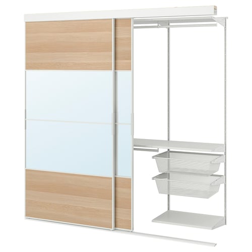 A white SKYTTA wardrobe with glass and wooden panels, featuring mesh drawers and a clothes rail.