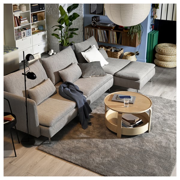 Modern living room with SÖDERHAMN light grey sofa-bed, wooden coffee table, and decorative items.