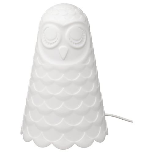 White, owl-shaped night lamp with soft light, made of polycarbonate and polypropylene plastic, sits on a table.