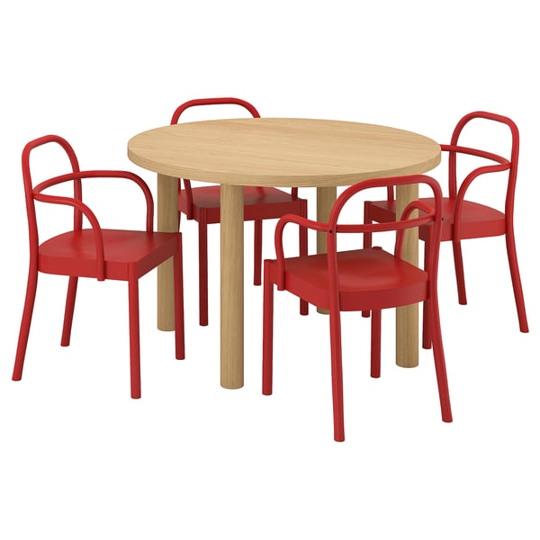 The STOCKHOLM 2025 set a light wooden round table surrounded by four red chairs with curved backrests and armrests.