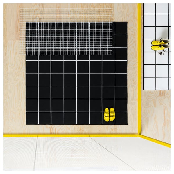 Black and white grid-patterned rug, square shape, indoor/outdoor use. Bright yellow accents, soft material, double-sided.